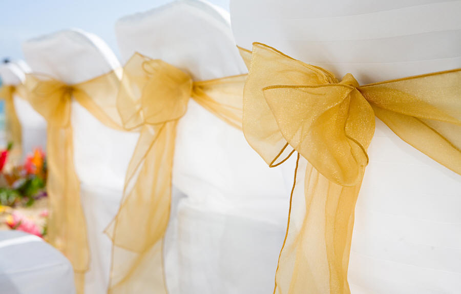 golden organza see through sash on a beach chair in Hawaii